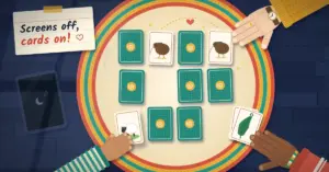 Illustration of a family playing a pairs memory game on a round braided rug on a rainy day, with a grandparent's hand in a mustard cardigan finding a matching pair of kiwi cards, a toddler sliding out a sheep card, a teenager resting a hand on a won pair of silver fern cards, a switched-off tablet nearby and a note reading "Screens off, cards on!"